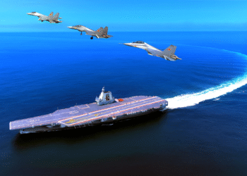 Aerial view of a Chinese Liaoning or Shandong aircraft carrier sailing at sea with several J-15 fighter jets flying overhead in formation