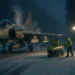 Saab Gripen E fighter jet being rearmed on a snowy highway base by ground crew