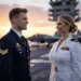 A cinematic photograph of a blonde US Army Sergeant in dress blues and a female US Navy Lieutenant in dress whites standing on an aircraft carrier flight deck during a golden hour sunset. F-35 jets and the carrier superstructure are visible in the background.