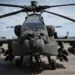 Front view of a US Army AH-64E Apache Guardian attack helicopter armed with Hellfire missiles and 30mm cannon, featuring the mast-mounted Longbow radar.