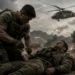 Battlefield combat medic treating a wounded soldier under active artillery fire while a military medical evacuation helicopter approaches overhead